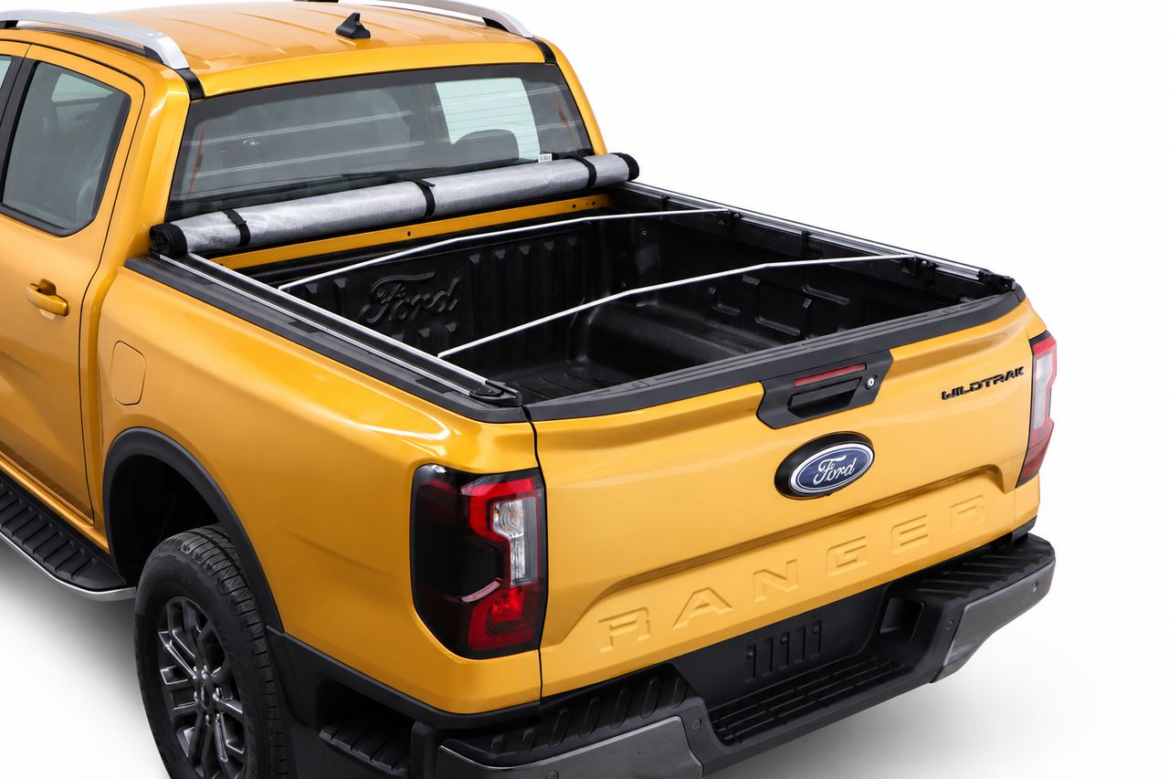 Softlid rolled up behind the cab with the support bows showing, tray fully open