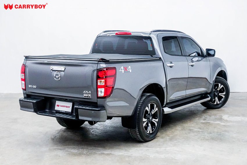 Grey Mazda BT-50 double cab with the Softlid closed, rear view