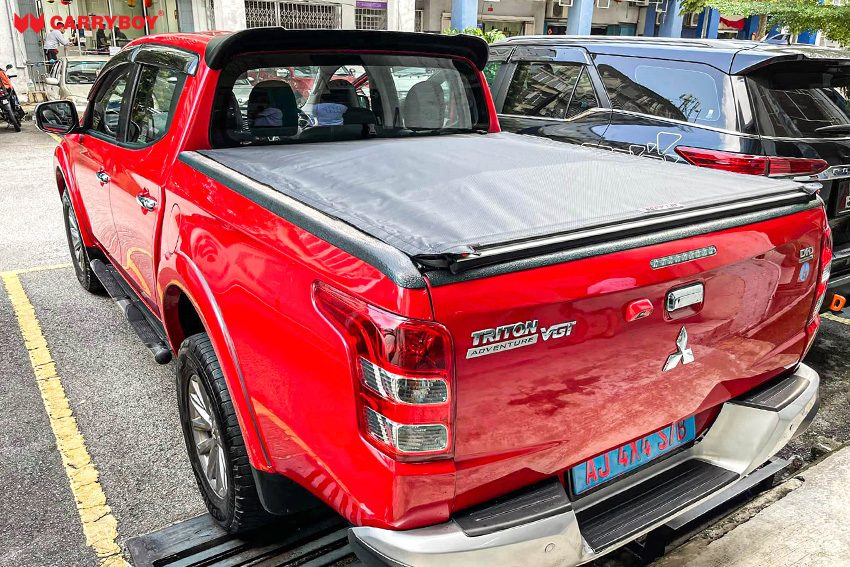 Red Mitsubishi Triton with the Softlid closed