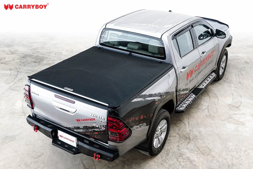 Silver Toyota Hilux Revo double cab with the Softlid closed, high rear view