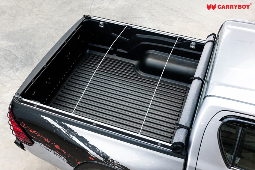 Top view of a Hilux Revo tray with the Softlid rolled up and the support bows in place