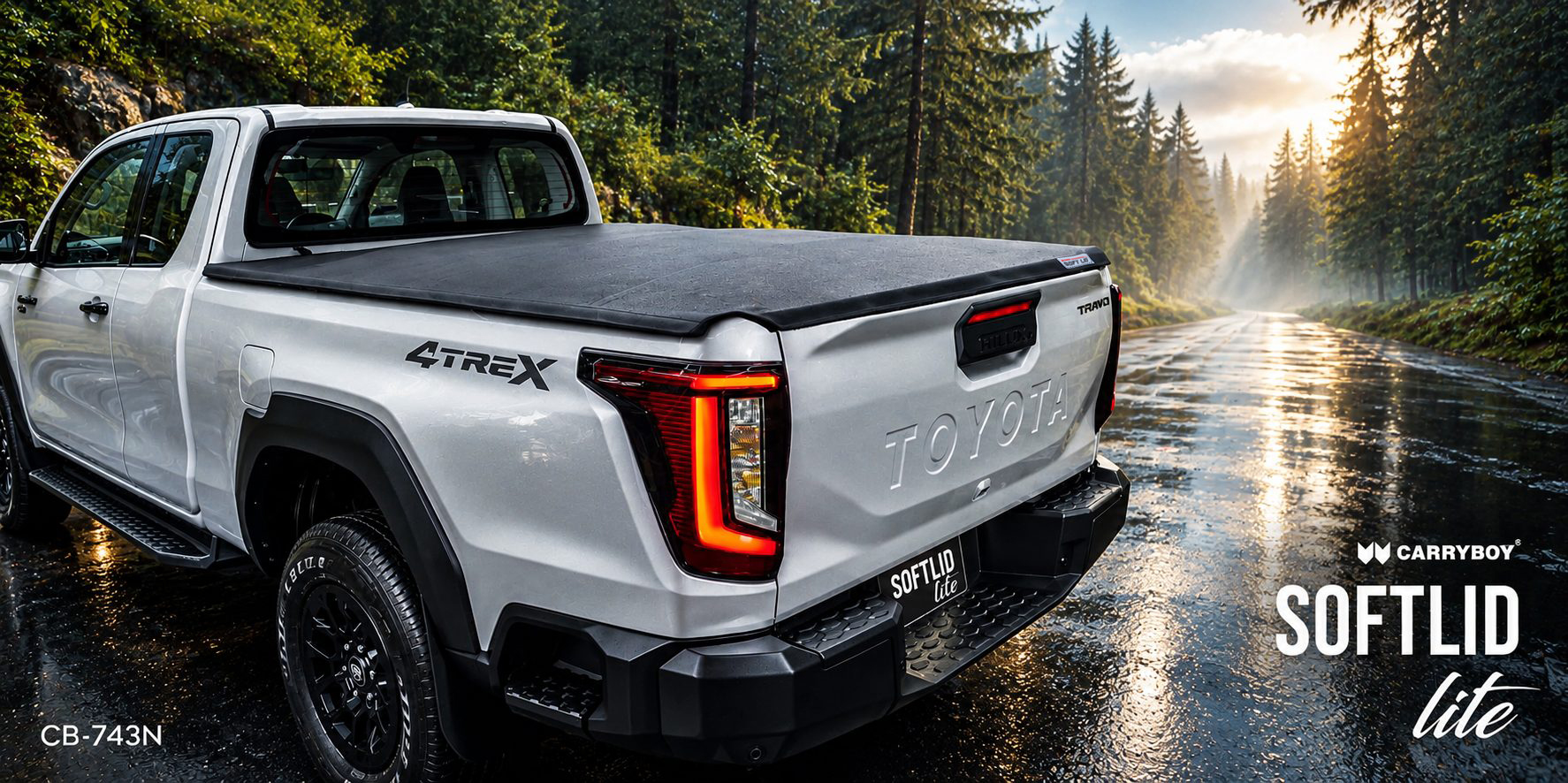 White Toyota Hilux Travo with the CARRYBOY Softlid Lite on a wet forest road