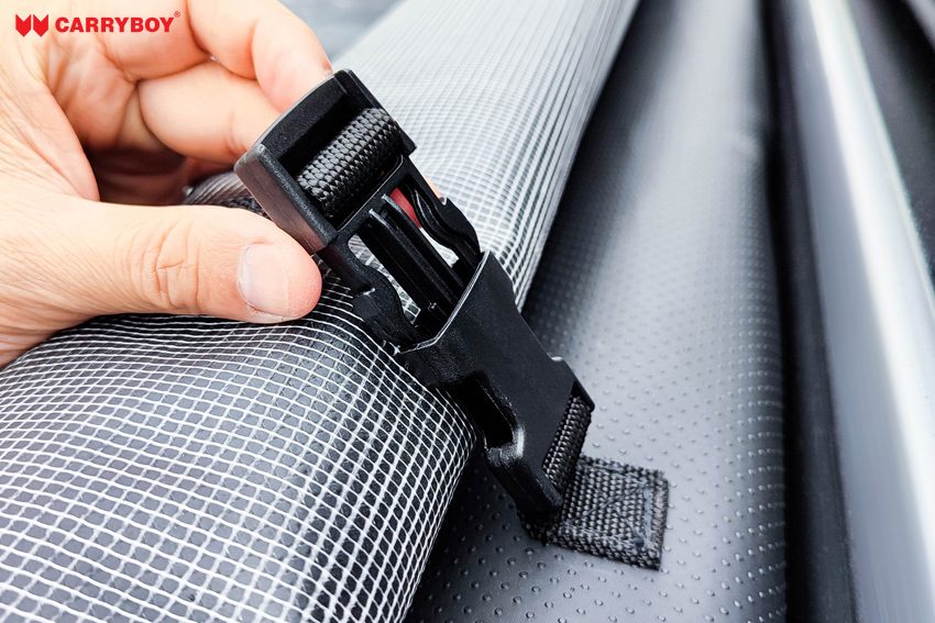 Buckle strap holding the rolled cover