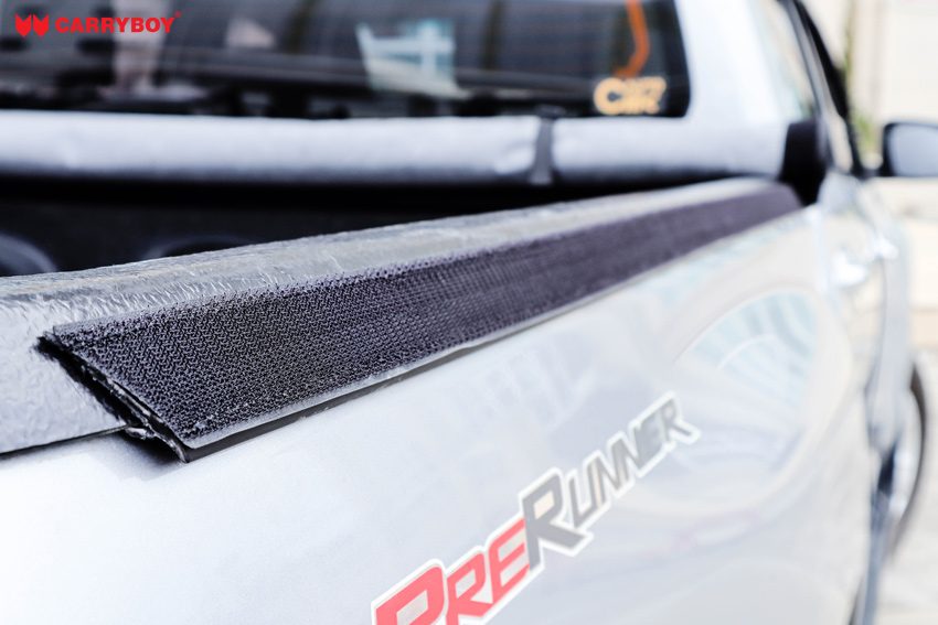Velcro strip running along the bed rail of a Toyota Hilux