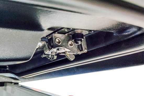 Rotary latch locking onto the striker on the truck bed rail