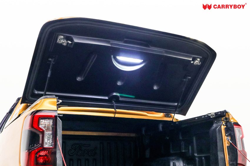 Full Box lid raised on gas struts with the LED light on above the tray