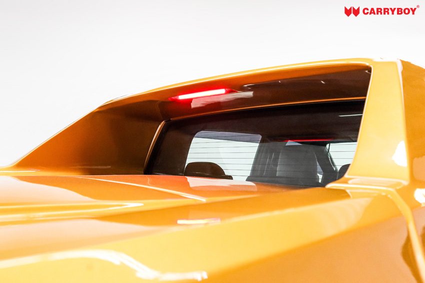 Third brake light shining above the cab's rear window inside the Full Box arch